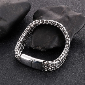 Detail of silver stainless steel woven chain bracelet with rectangular magnetic clasp