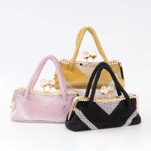 Elegant rhinestone evening handbags in pink, gold, and black with beaded handles