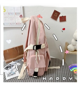 Detailed side view of pink canvas backpack featuring buckle closure and mesh water bottle pocket