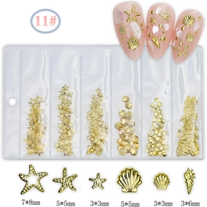 Detail of 11# gold ocean-themed nail charms set with shells, starfish and conches