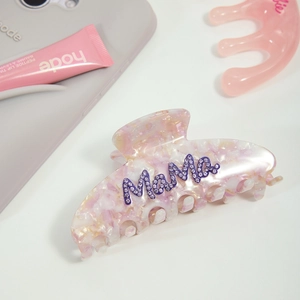 Macro view of purple marble acetate hair claw clip with crystal Mama letter design