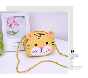 Detail of cute yellow tiger cartoon crossbody bag for kids with gold rope strap