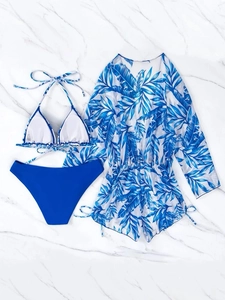Flat lay of blue tropical leaf print three-piece bikini set with long sleeve cover-up