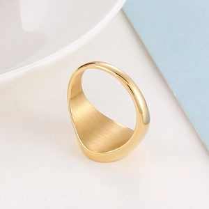 Detailed macro view of gold plated ring showing brushed surface and polished inner finish