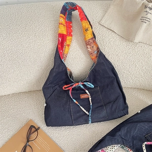 Detail of corduroy tote bag featuring colorful patterned lining and cute ribbon bow detail