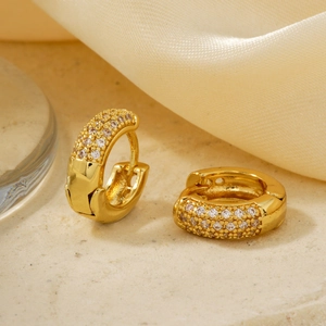 Macro shot of gold-plated hoop earrings with micro-paved white cubic zirconia stones