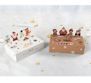 Macro view of 3D Christmas gift boxes featuring Santa, reindeer and snowman toppers