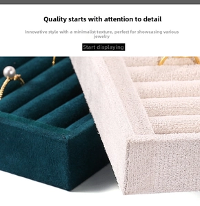 Detail view of velvet jewelry display trays for rings and earrings in green and beige