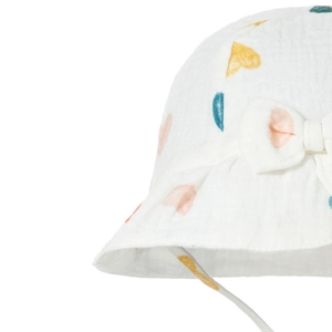White cotton baby sun hat with colorful heart print and decorative bow detail