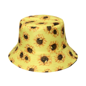 Women's yellow cotton bucket hat with vibrant sunflower patterns and a flat top style