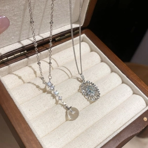 Close-up of vintage oval hollow pendant with blue gemstone and zircon on velvet tray
