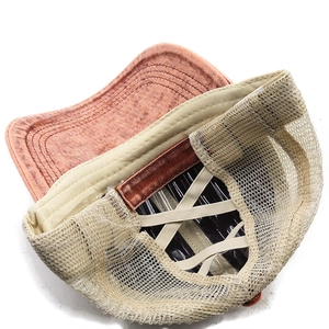 Detail view of the breathable mesh back and criss-cross elastic bands for ponytails