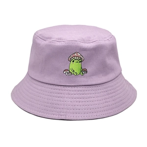 Detailed embroidery of a green frog and mushrooms on a purple cotton bucket hat
