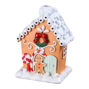 Christmas gingerbread snow house decoration with warm orange resin and white snow rooftop