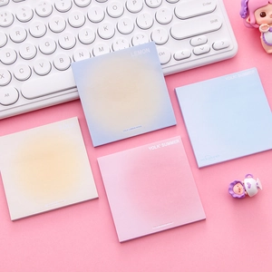 Gradient aesthetic sticky notes for planners in blue and pink on a pink desk setting