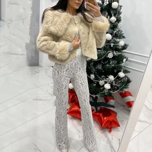 Fashionable beige plush jacket paired with patterned silver trousers for a festive look