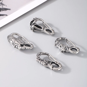 Assorted titanium steel clasps with skull, buddha, and animal head designs in vintage silver
