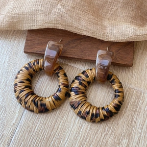 Retro resin and leopard print geometric hoop earrings on a vintage wooden base