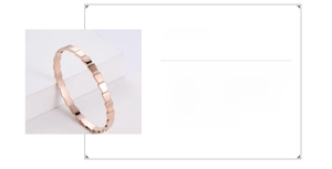 Detail view of 316L stainless steel rose gold bangle with geometric faceted design
