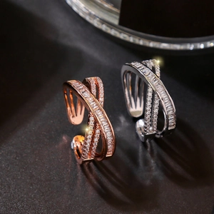 Detail of adjustable crisscross rings in rose gold and silver with zircon pavé setting