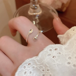 Close-up of adjustable silver open ring featuring unique miniature spoon and fork design
