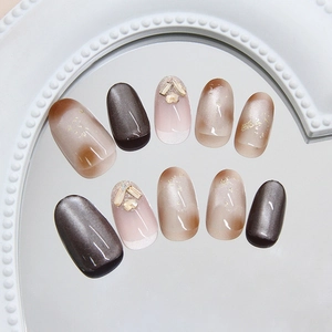 Brown cat eye press-on nails with champagne rhinestones and gradient design