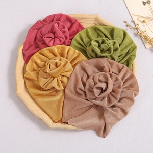 Infant turban hat with rosette flower in red, green, gold, and brown tones