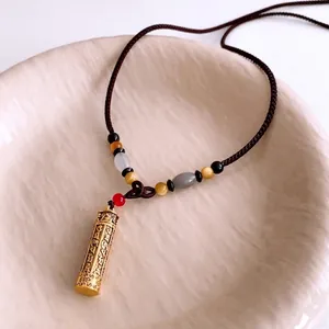 Tiger eye beaded necklace with engraved golden cylinder pendant in retro ethnic style