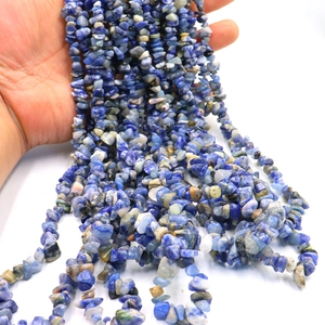 Macro shot of natural lapis lazuli crushed stone beads for handmade jewelry crafts