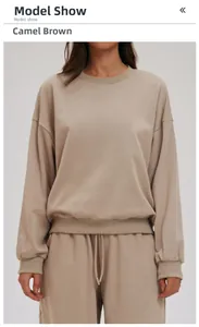 Detail view of camel brown crewneck sweatshirt set featuring ribbed cuffs and hem