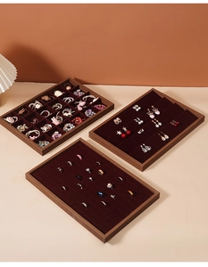 Detail view of walnut wood jewelry tray set with deep red velvet lining for rings
