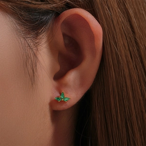 Close-up of S925 silver stud earrings with marquise-cut green zircons in gold setting
