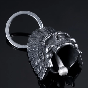 Detailed macro view of vintage stainless steel Indian skull bell pendant with feathers