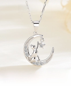 Close-up of S925 sterling silver moon and cat pendant with sparkling zircon accents
