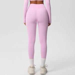 Rear view of pink high-waisted yoga leggings and long sleeve cropped sports top on a model