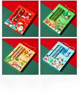Close-up of a 6-piece Christmas stationery set including pencils, ruler, and notebook