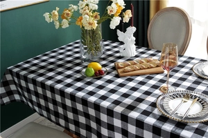 Detailed view of black and white checkered tablecloth texture for elegant dining decor