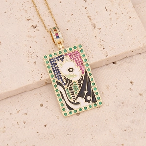 Detailed close-up of tarot card pendant with Egyptian cat enamel on beige stone