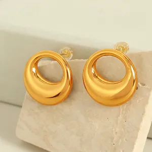 Polished 18K gold-plated oval hollow moon stud earrings on minimalist stone display