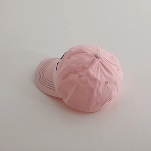 Pink cotton baseball cap for girls featuring navy blue embroidered letters and sun protection