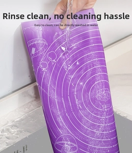 Water rinsing a purple silicone baking mat with measurement scales for easy cleaning