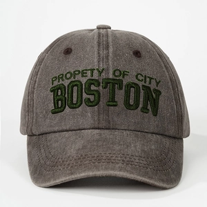 Close-up of green 3D embroidery showing Property of City Boston on washed cotton baseball cap