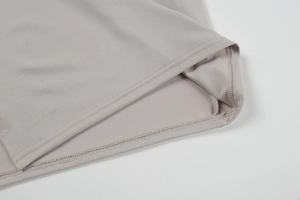 Detailed close-up showing high-quality flatlock stitching on grey knit dress hem
