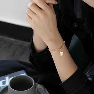 Gold chain bracelet with round coin pendant featuring Trust in the Lord engraving