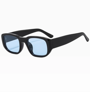 Close-up of retro square sunglasses with a black frame and light blue lenses for street style