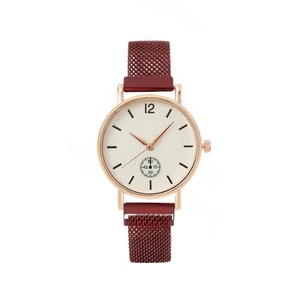 Detail of rose gold case with white dial and red magnetic Milanese mesh strap