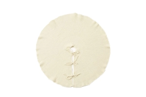 Detailed cream knit Christmas tree skirt featuring cozy yarn texture and ribbon bow ties