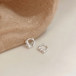 Minimalist S925 sterling silver hoop earrings with triple bead detail on neutral background