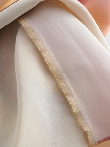 Detailed close-up of the professional hem stitching and satin fabric texture