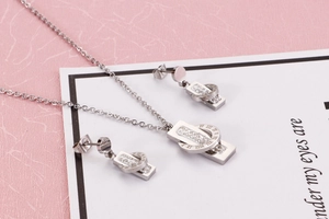 Detail of silver jewelry set with Roman numeral rings and sparkling pavé crystals